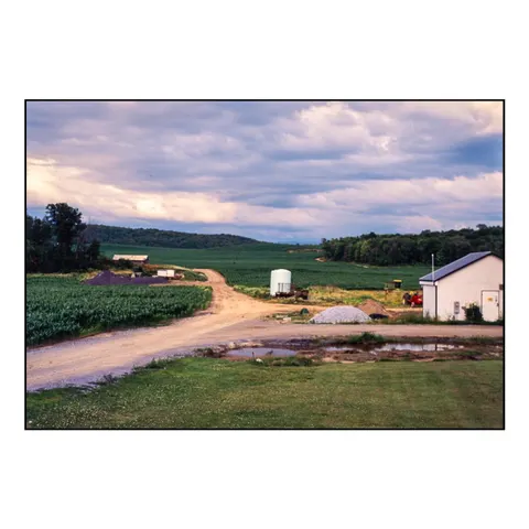 Farm road under violet clouds